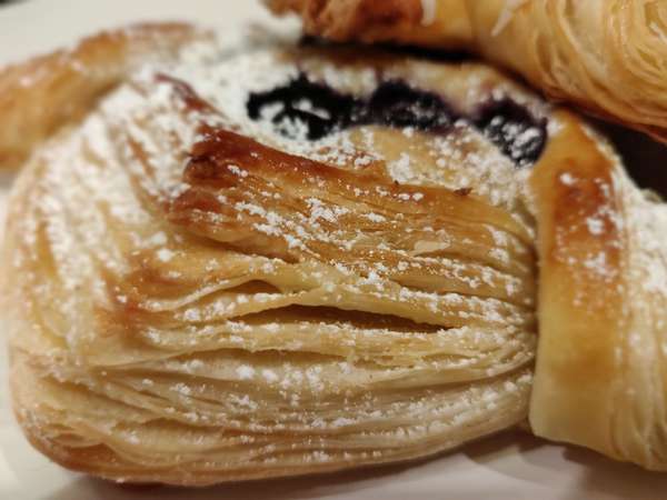 close up of the layers of a blueberry danish